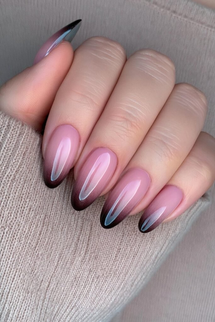 Short almond nails with a seamless smoky black-to-chocolate brown ombré and glossy finish.