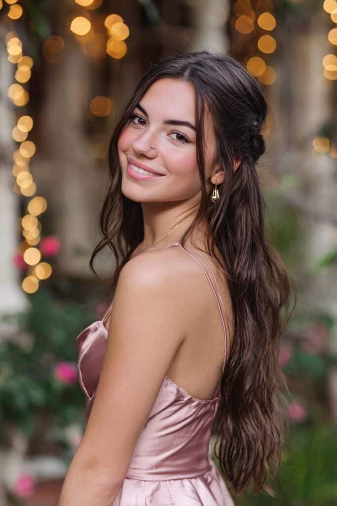 Boho loose waterfall braid with soft beachy waves and romantic texture for a relaxed yet elegant homecoming hairstyle.