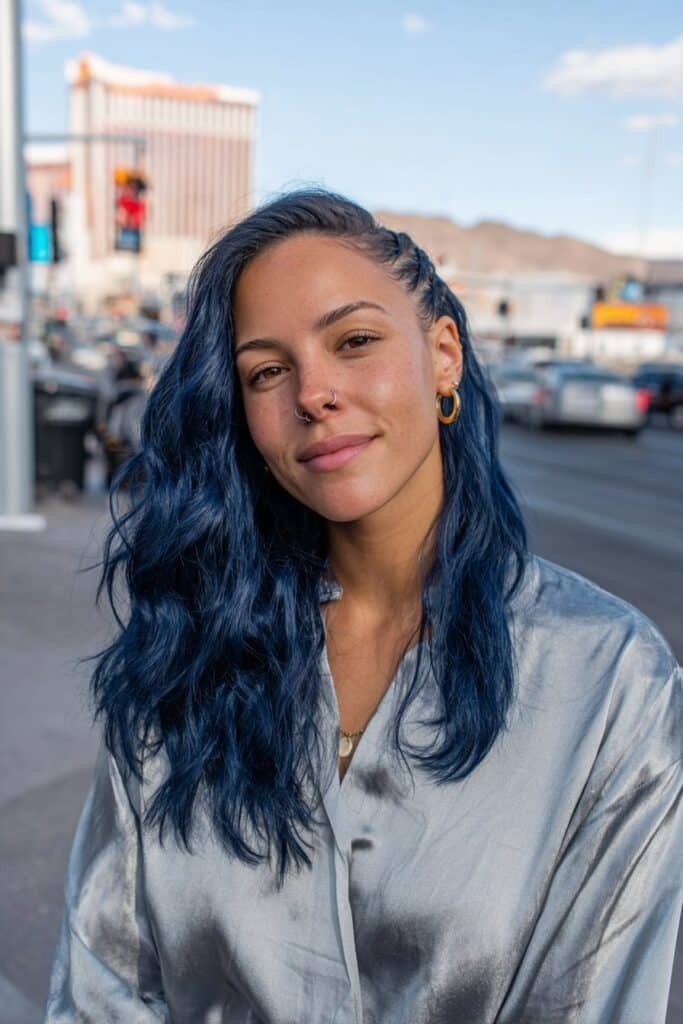 Medium close-up portrait showcasing bold all-over midnight blue statement hair