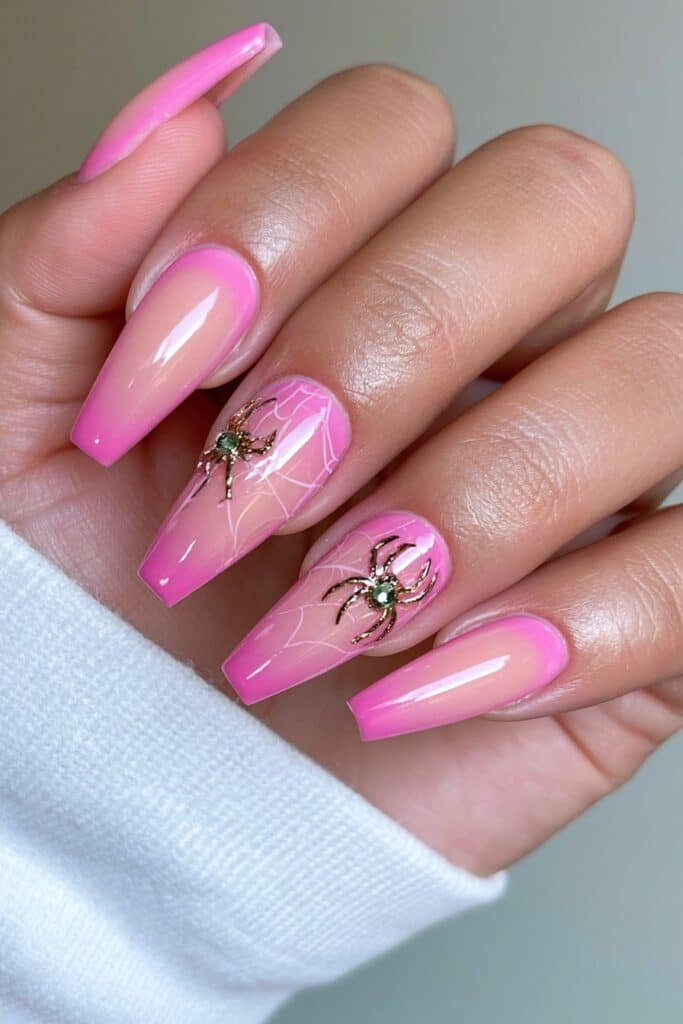 Bold pink coffin nails with spider charms and web accents.