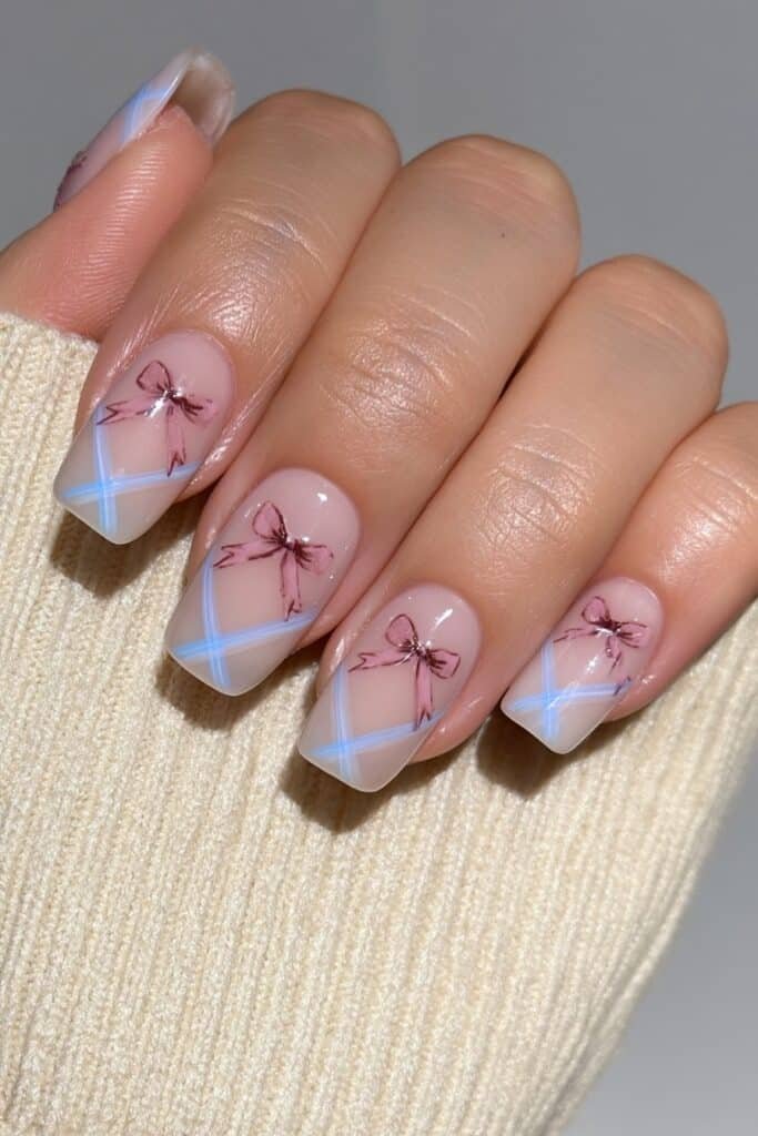 Sheer nude nails with tiny dusty rose bow stamp accents.