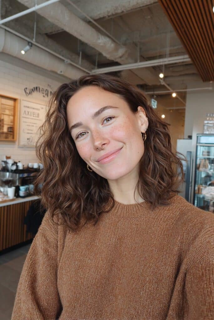 Brown sugar brunette hair with soft curls and glossy salon-quality shine.