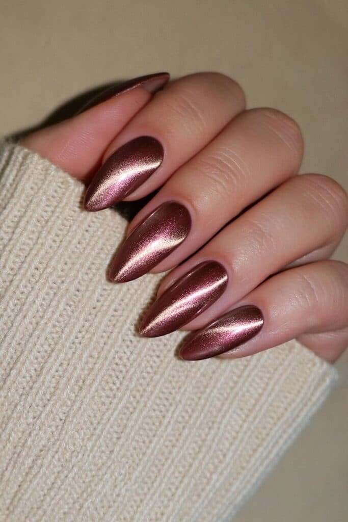 Brown velvet magnetic almond nails with delicate metallic gold accents.