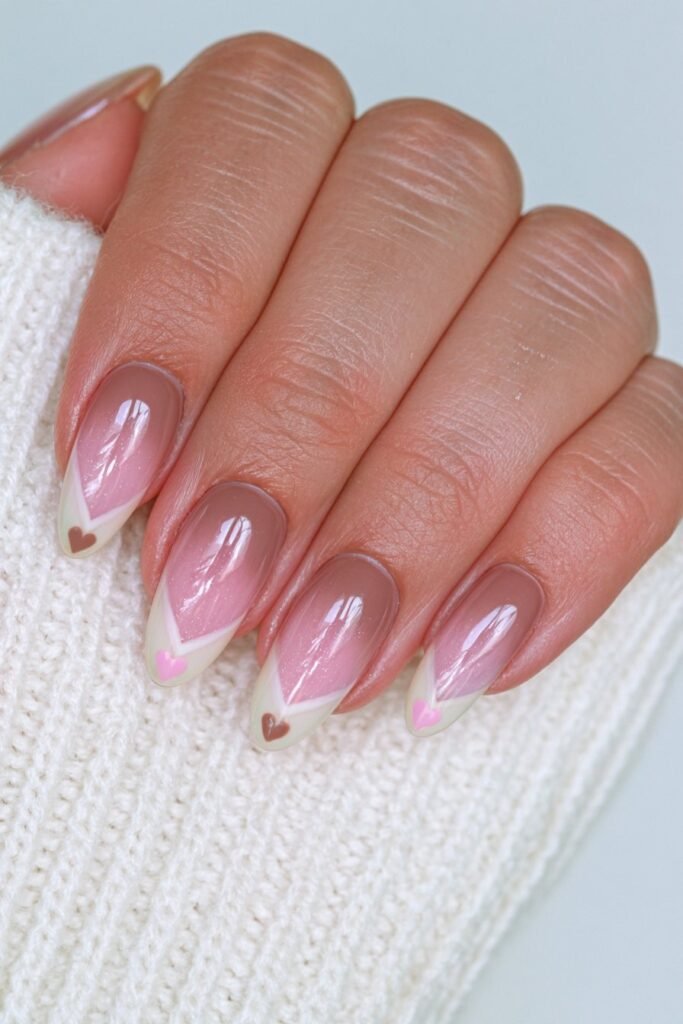 Short oval chocolate brown and ivory nails with tiny alternating heart accents.