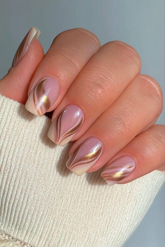 Short buttercream nails with fine brown stripes.