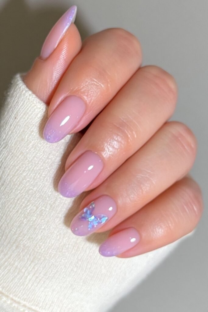 Short nude nails with a magnetic butterfly chrome accent.