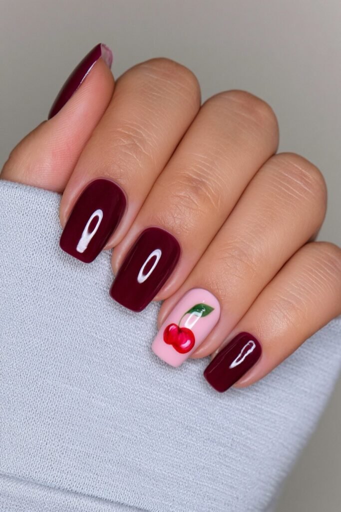 Short cherry red squoval nails with glossy finish.