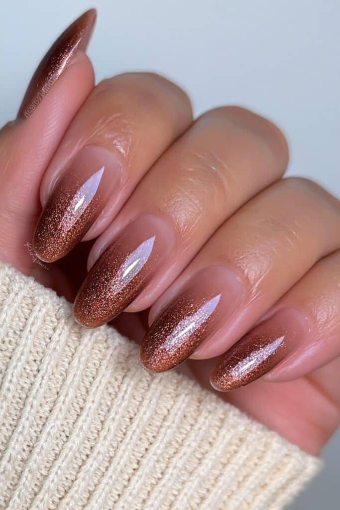 Short almond nails with a seamless chestnut brown ombré fading into warm nude.