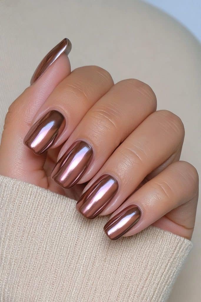 Short squoval nails with reflective chocolate brown chrome finish