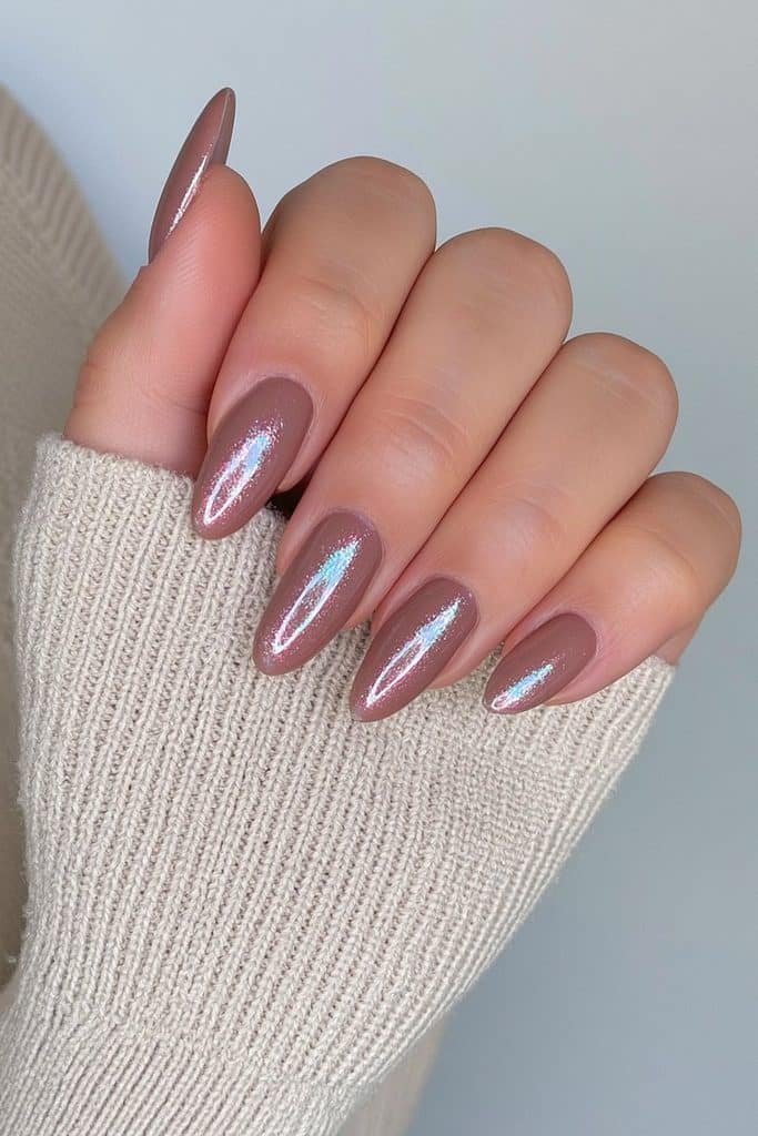 Short almond nails in creamy chocolate brown with a glossy glazed chrome finish.