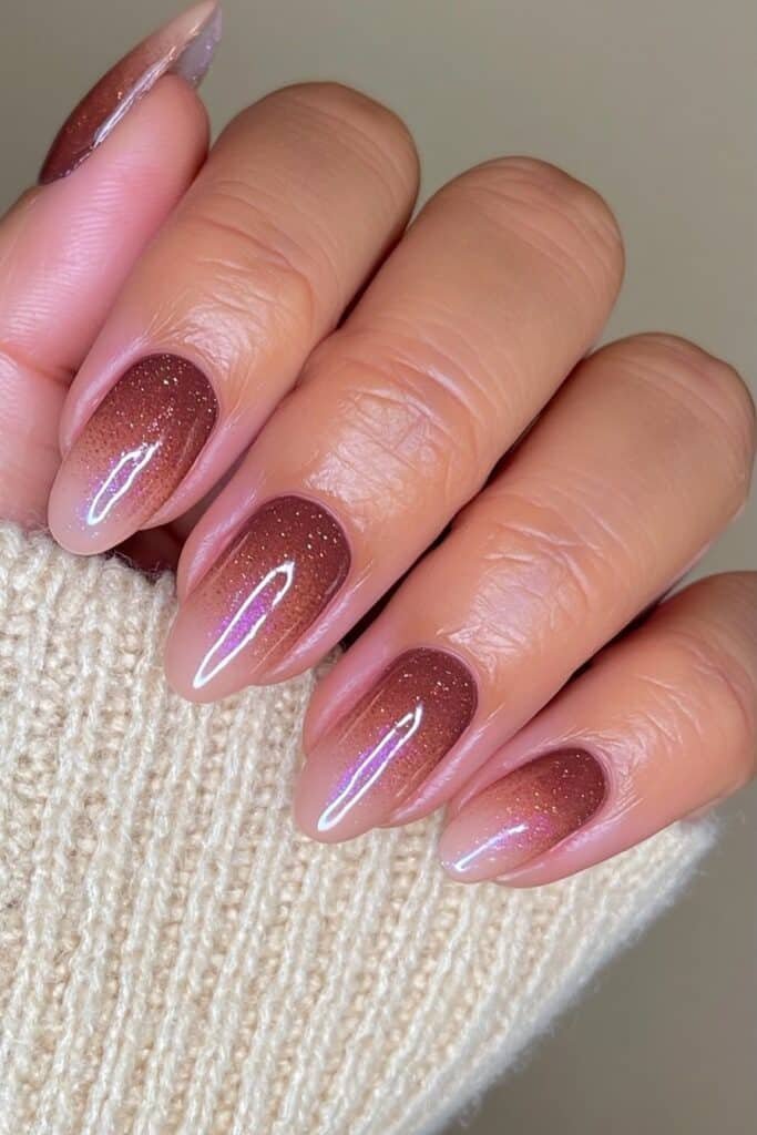 Chocolate brown nails fading into creamy nude with glossy shine.