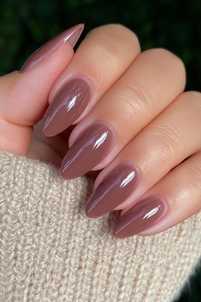 Short round Thanksgiving nails in rich glossy cinnamon brown.