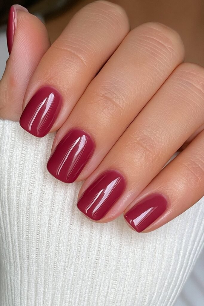 Short cherry red nails with a classic glossy shine.