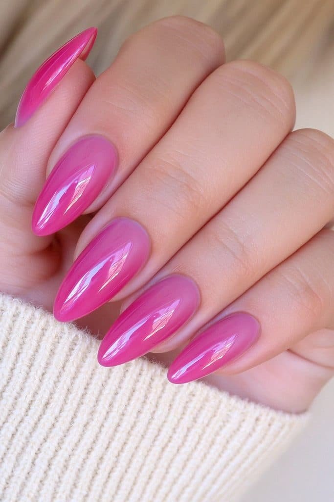 Short almond nails in classic cherry red with an ultra-glossy finish.