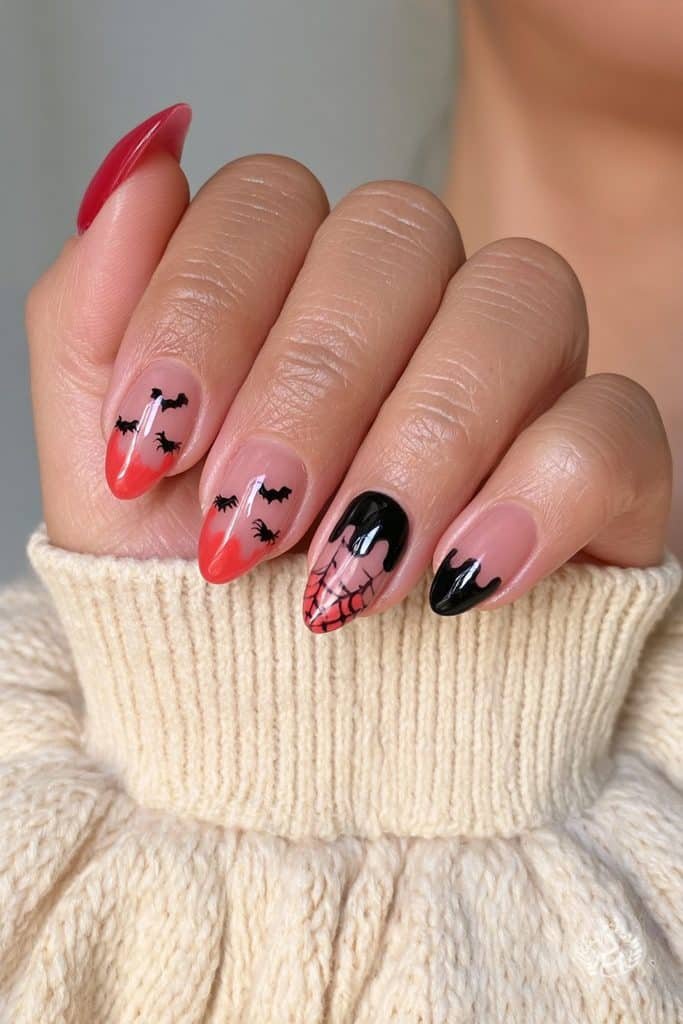 Short dark orange and black Halloween nails with tiny spooky accents.