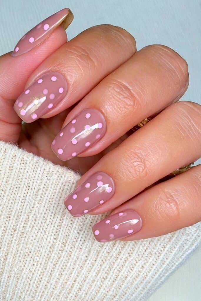 Short cocoa brown nails with pale pink polka dots.
