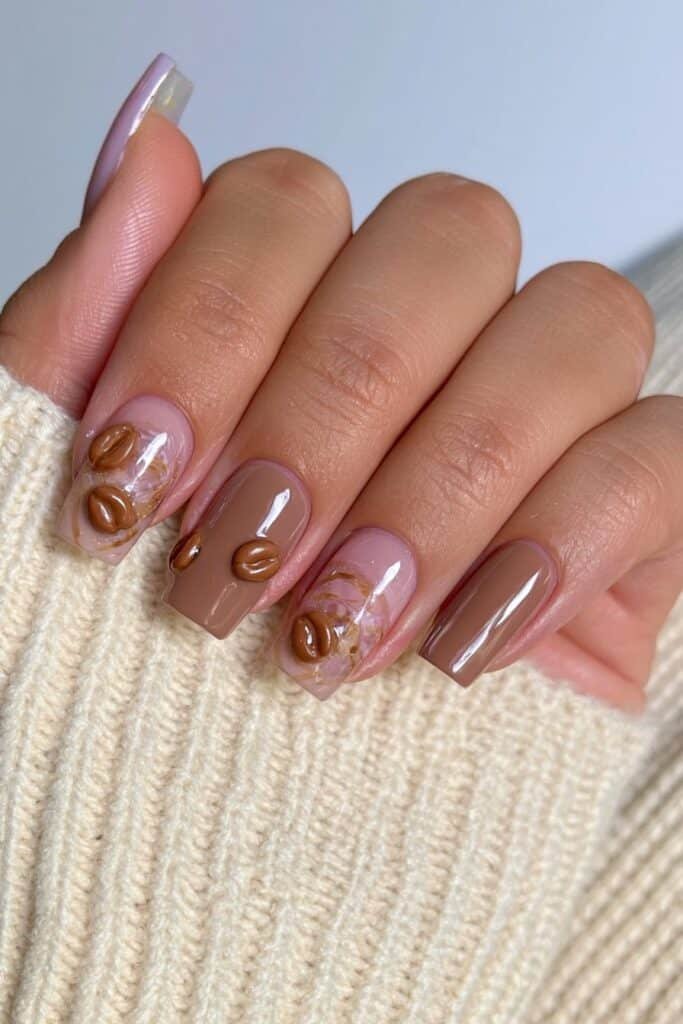 Short squoval espresso and mocha nails with tiny raised 3D coffee bean accents.