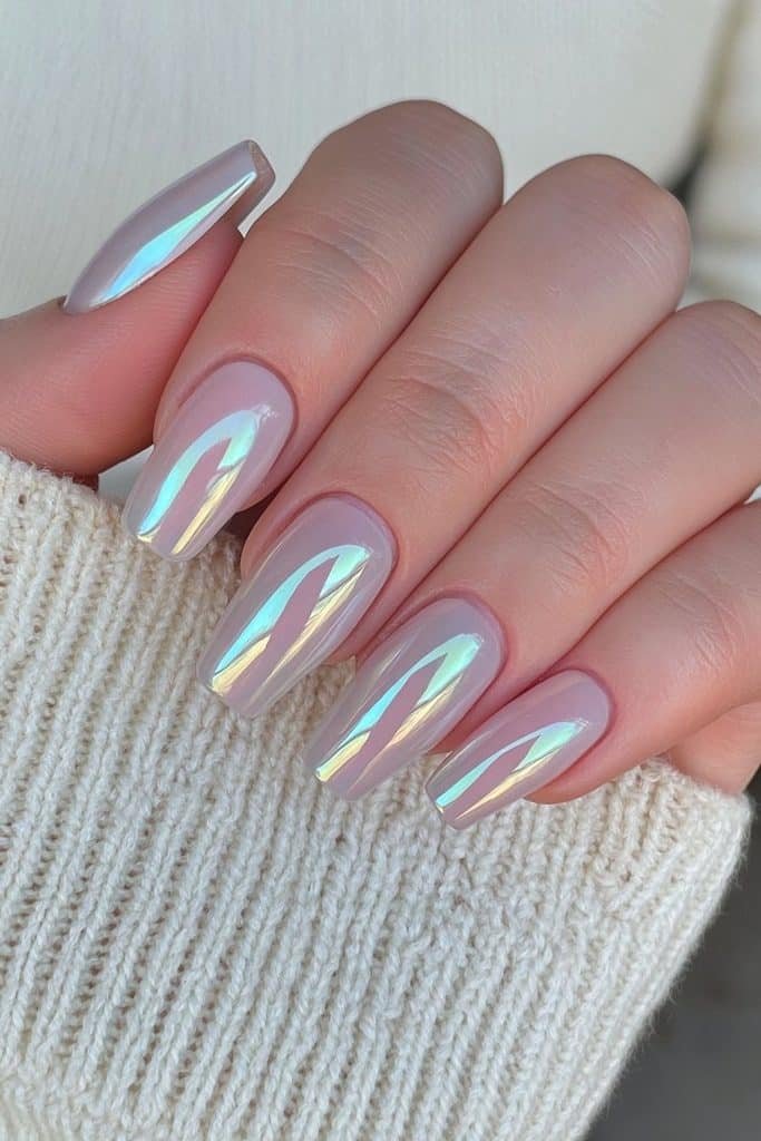 Short coffin-shaped nails in sheer blush nude with a translucent glazed chrome finish.
