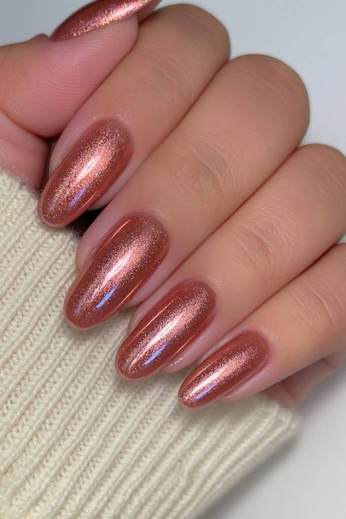 Short round Thanksgiving nails in shimmering warm copper brown with glossy finish.
