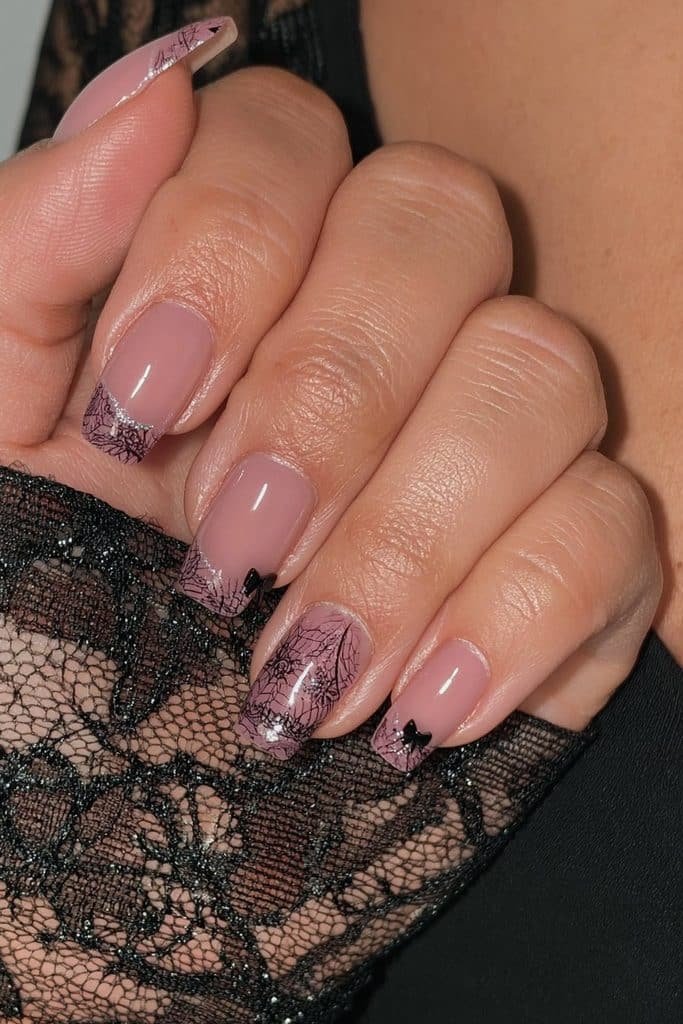Short nails with delicate black gothic lace and bow details.
