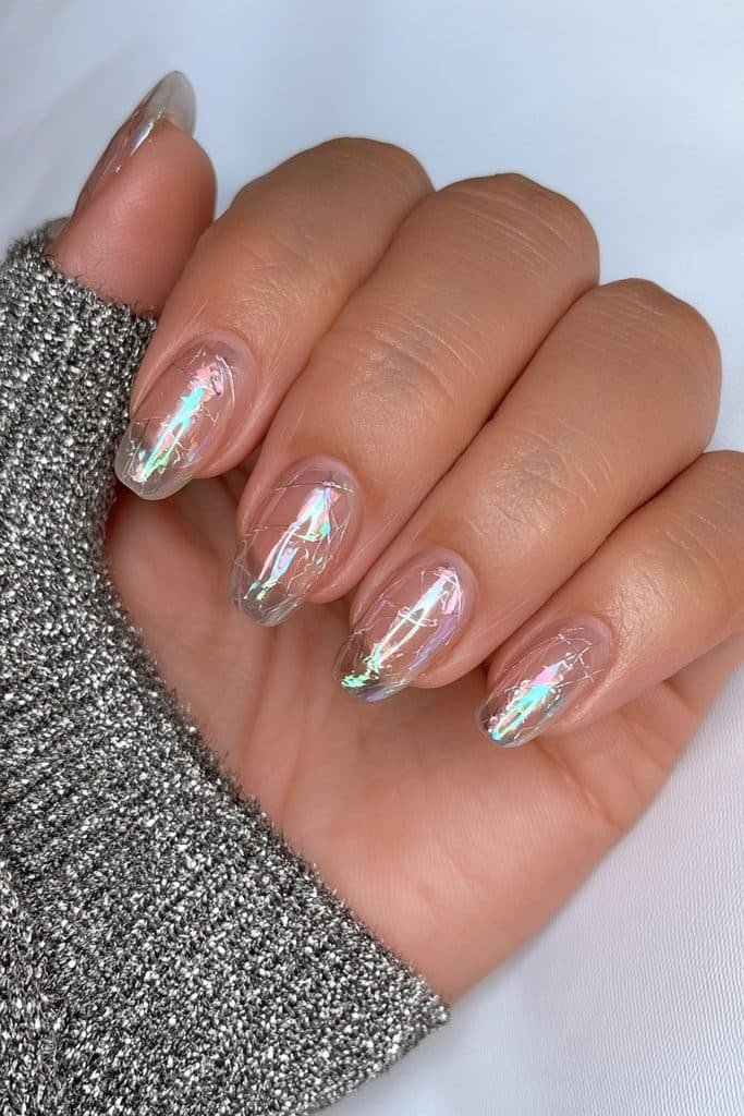 Short smoky chrome nails with delicate cracked-glass detailing.