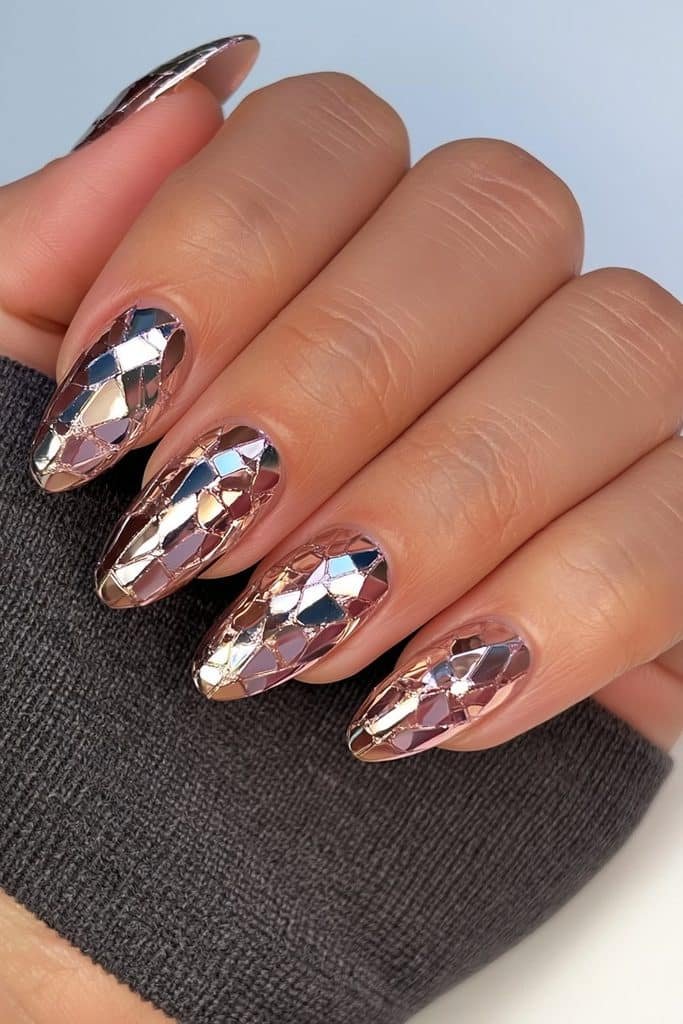 Short smoky chrome almond nails with delicate cracked-glass details.