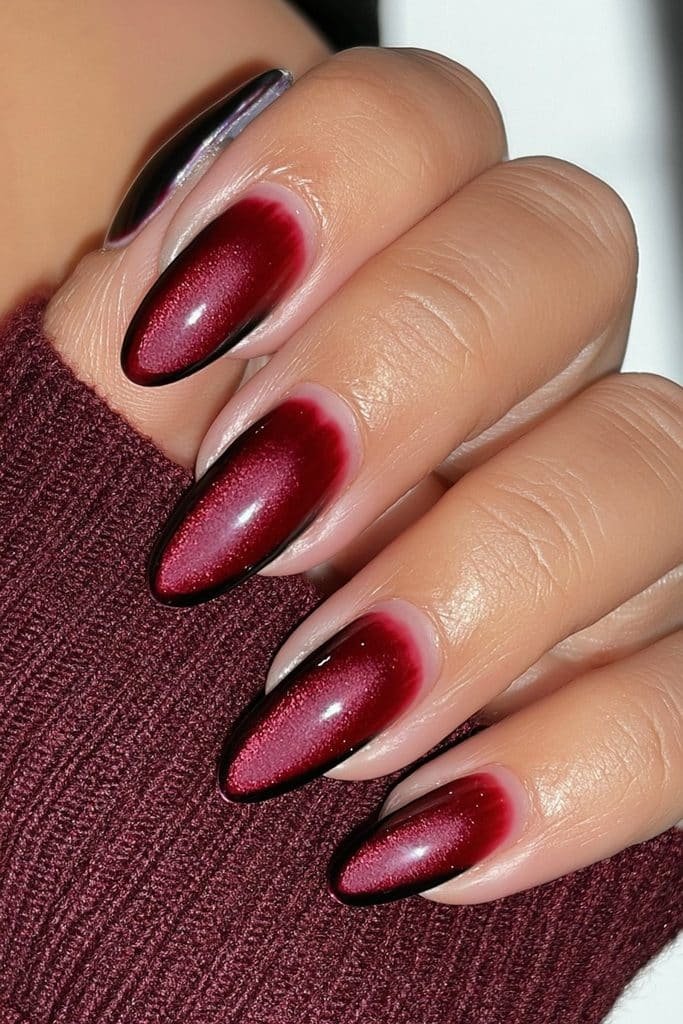 Short almond nails in dark red with a luxurious velvet-matte finish.