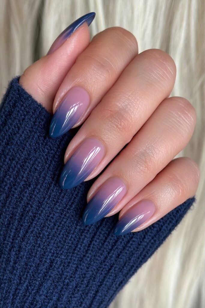 Midnight blue ombre almond nails with a smooth mirror-gloss finish.