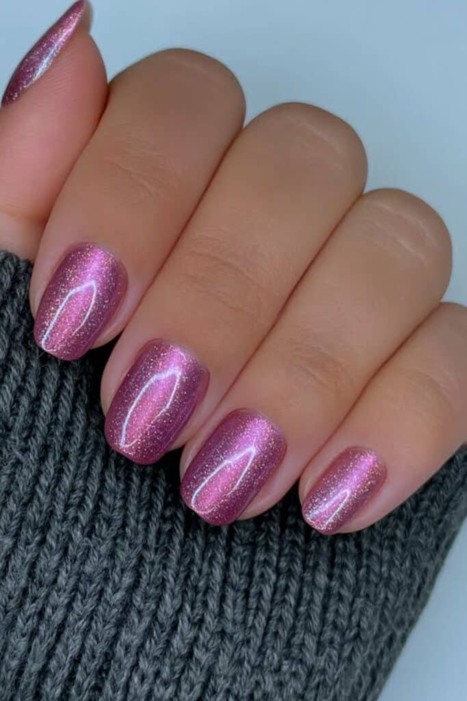 Short deep plum cat-eye nails with magnetic shimmer.