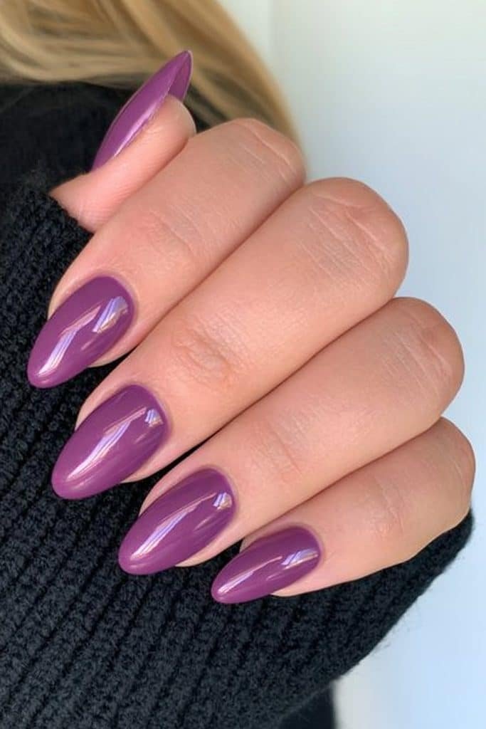 Short deep royal purple almond nails with an ultra-glossy finish.