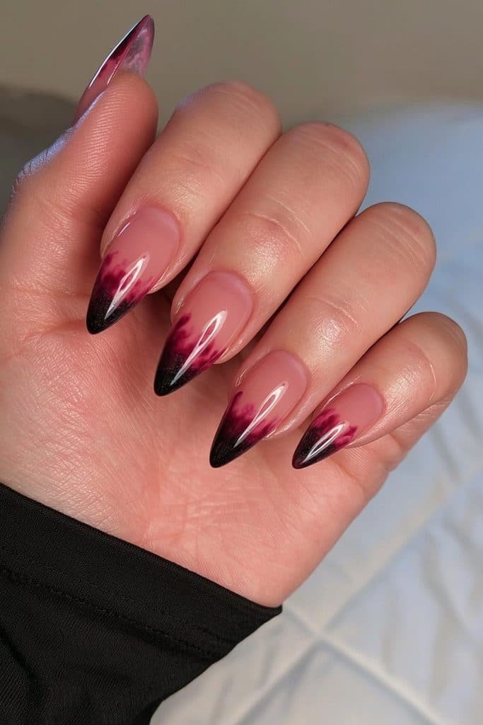 Short almond nails with translucent deep red jelly fading into smoky black.