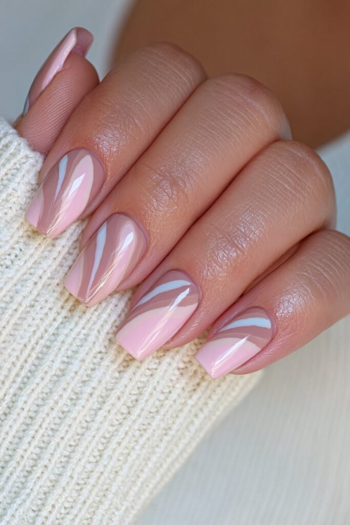 Short nails with espresso brown and cream swirl designs.