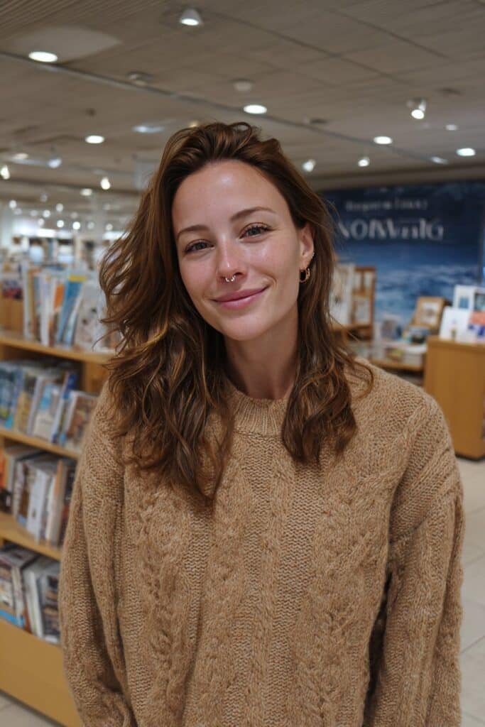 Brunette hair with bright face-framing caramel highlights and soft layered waves.
