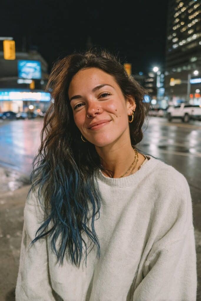 Medium close-up portrait showcasing layered hair with faded denim-blue tips