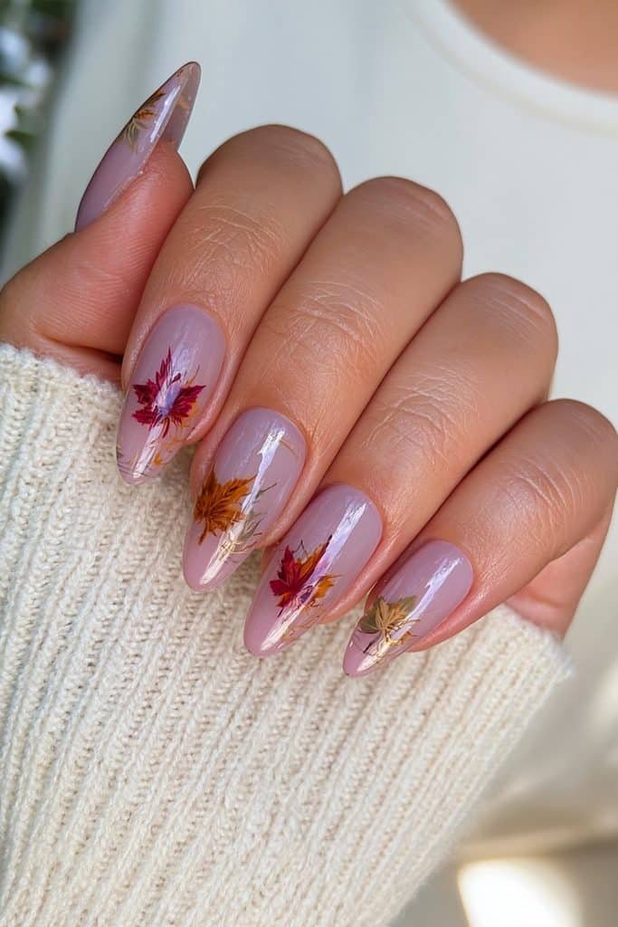 Short oval Thanksgiving nails with delicate burnt-orange and brown fall leaf line art.
