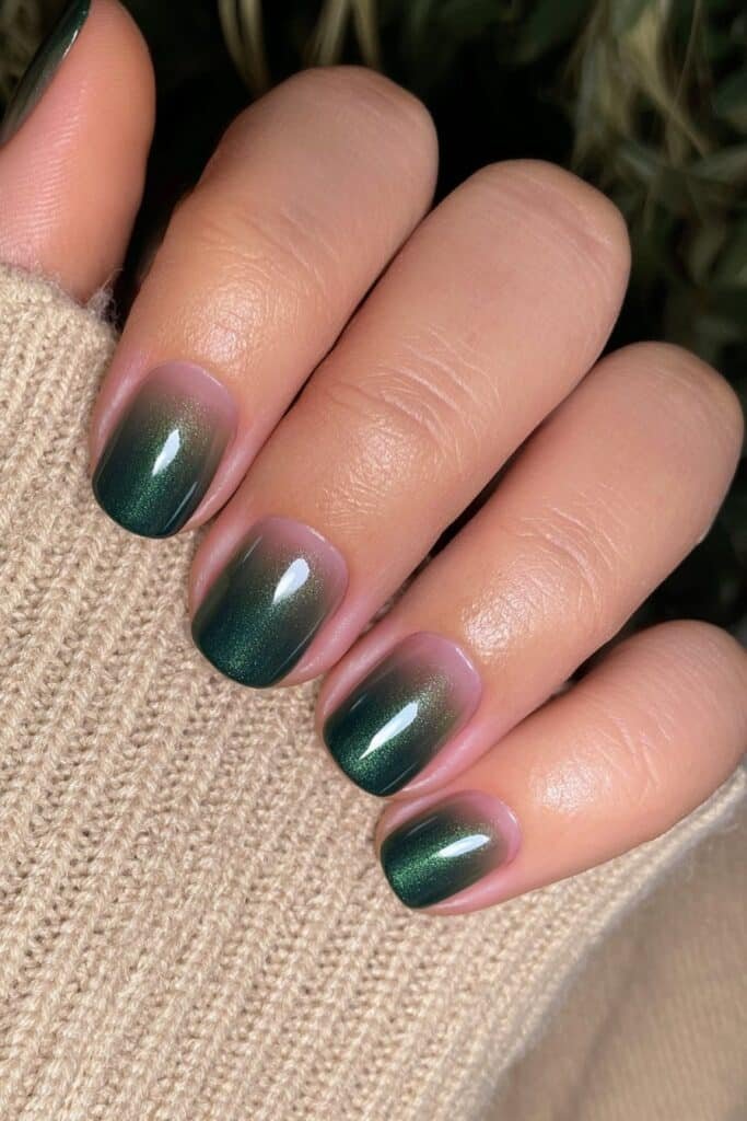 Short forest green nails with a glossy salon finish.