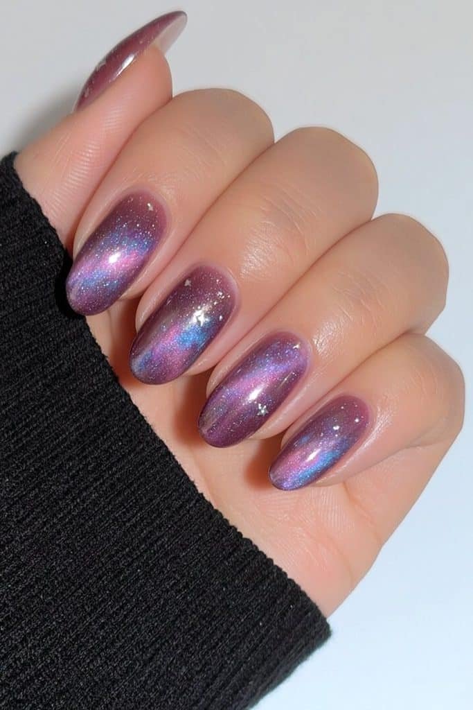 Short purple galaxy nails with silver stars and subtle nebula shimmer.