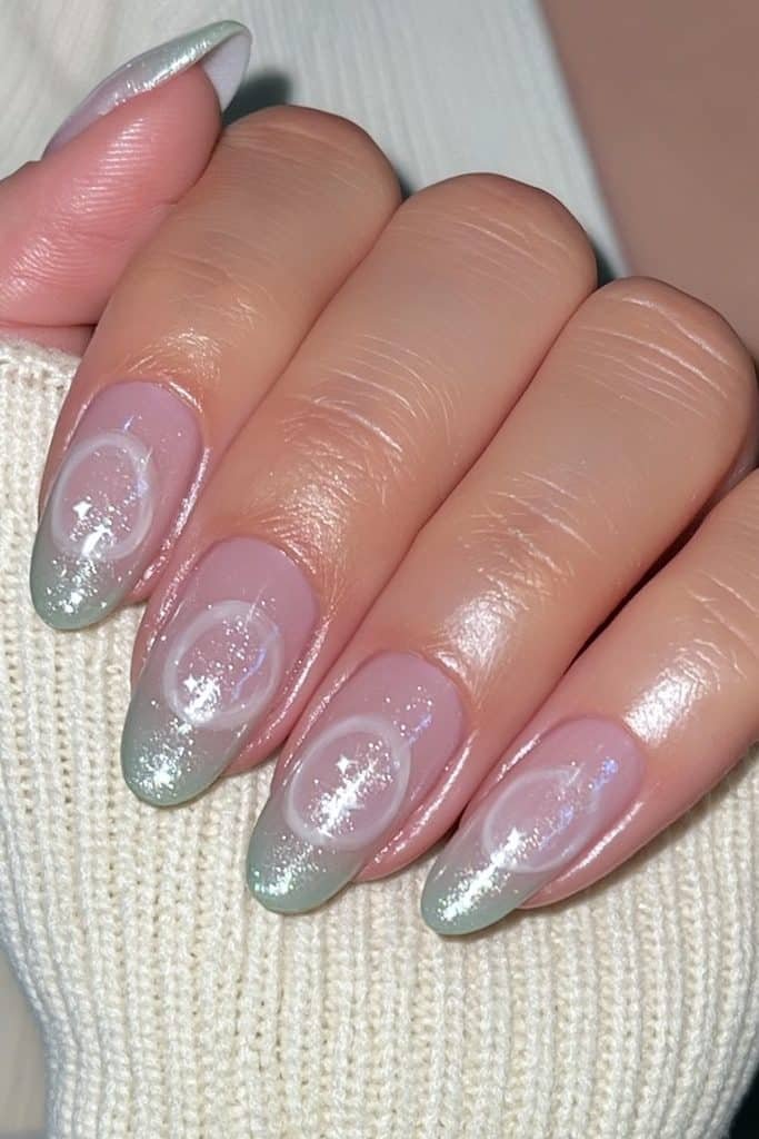 Short round nude nails with creamy white swirl details and a pearlescent glaze.