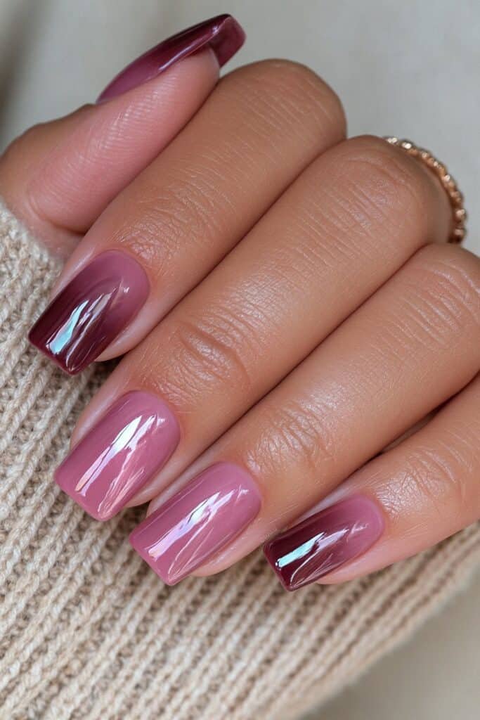 Short glossy burgundy nails with deep wine-toned color.