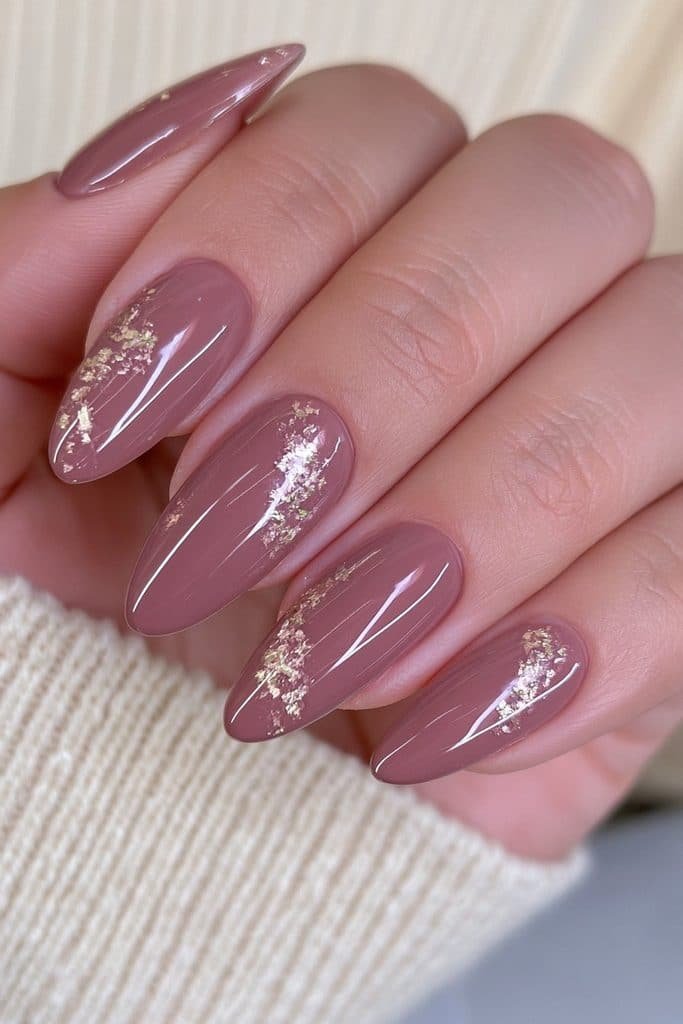 Short almond nails in chocolate brown with delicate gold foil accents