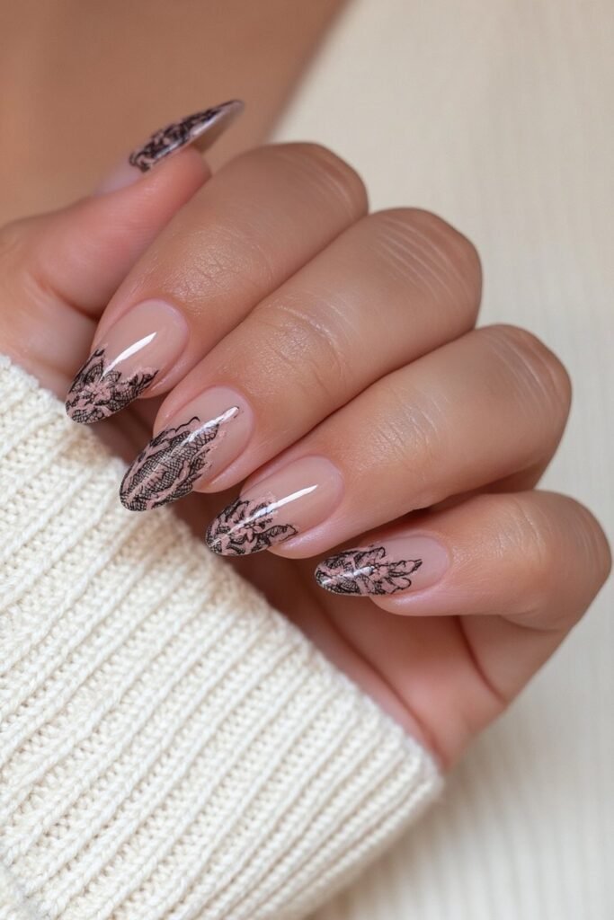 Sheer beige nails with delicate black lace accent details.