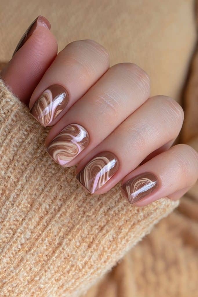 Short round chocolate brown nails with creamy latte swirl accents