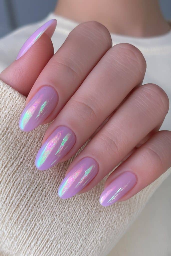 Short oval nails in translucent lavender with an iridescent glazed chrome finish.