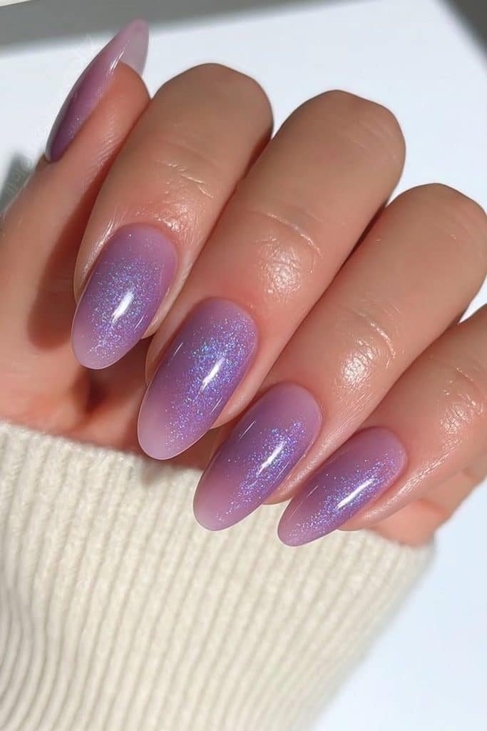 Short oval nails in soft lavender velvet with subtle violet shimmer.