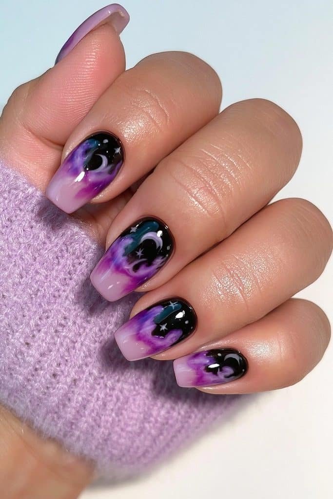Short lavender and black nails with tiny witchy moon and star details.