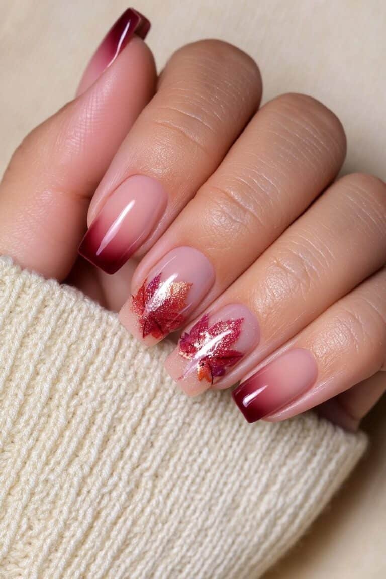 Short nude nails with a maple leaf autumn accent.