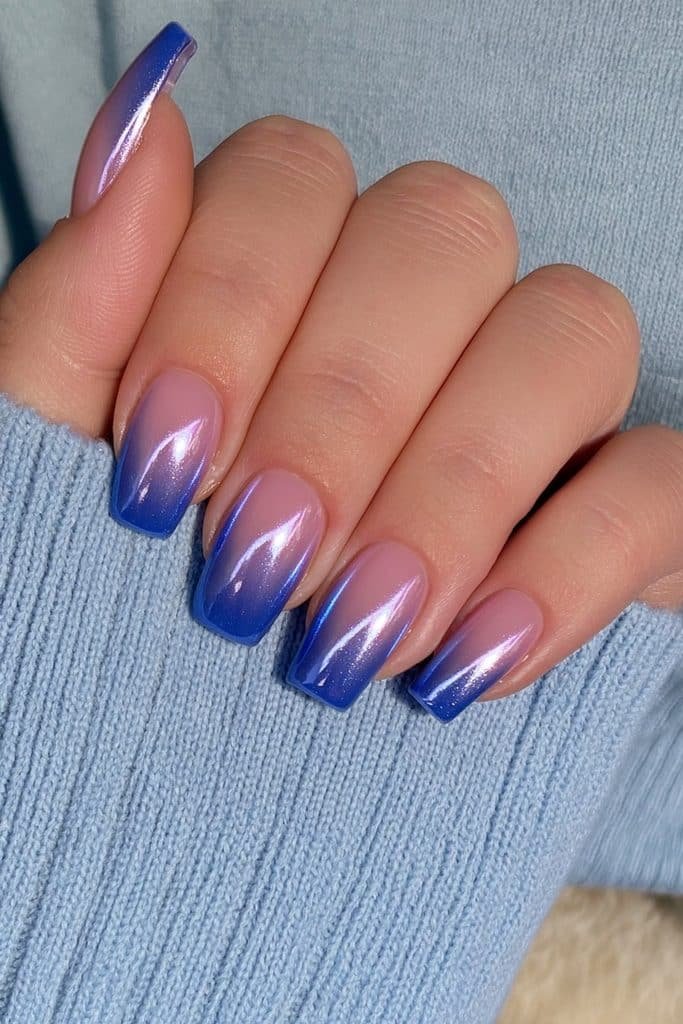 Short squoval nails in translucent icy blue with a luminous metallic chrome glaze.