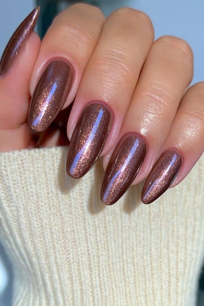 Short almond nails in chocolate brown with fine bronze-gold shimmer