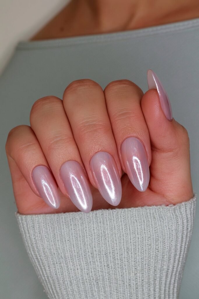 Metallic silver chrome almond nails with a reflective mirror finish.