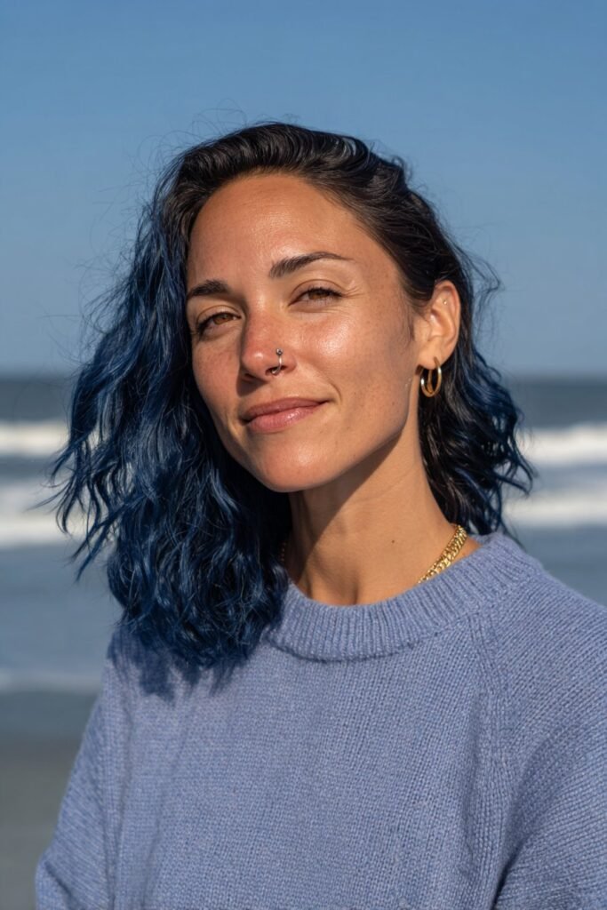 Medium close-up portrait featuring long midnight blue waves with glossy texture